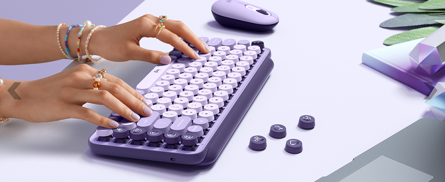 zoom of a woman typing on pop keys cosmos compact wireless mechanical lavender purple keyboard
