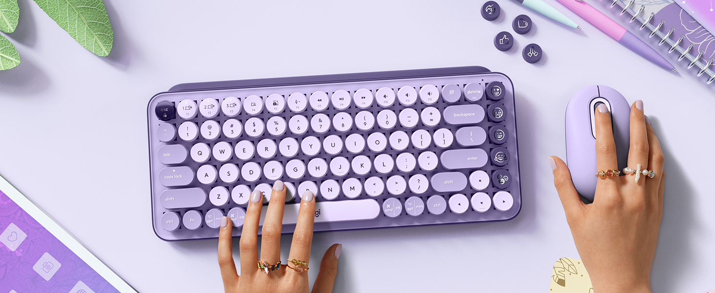 zoom of a woman typing on pop keys cosmos compact wireless lavender purple keyboard using pop mouse